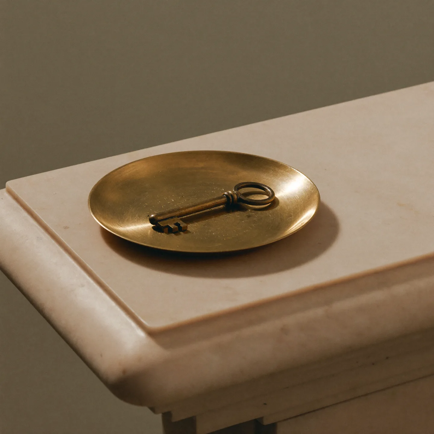 A brass key on a brass dish, handed over