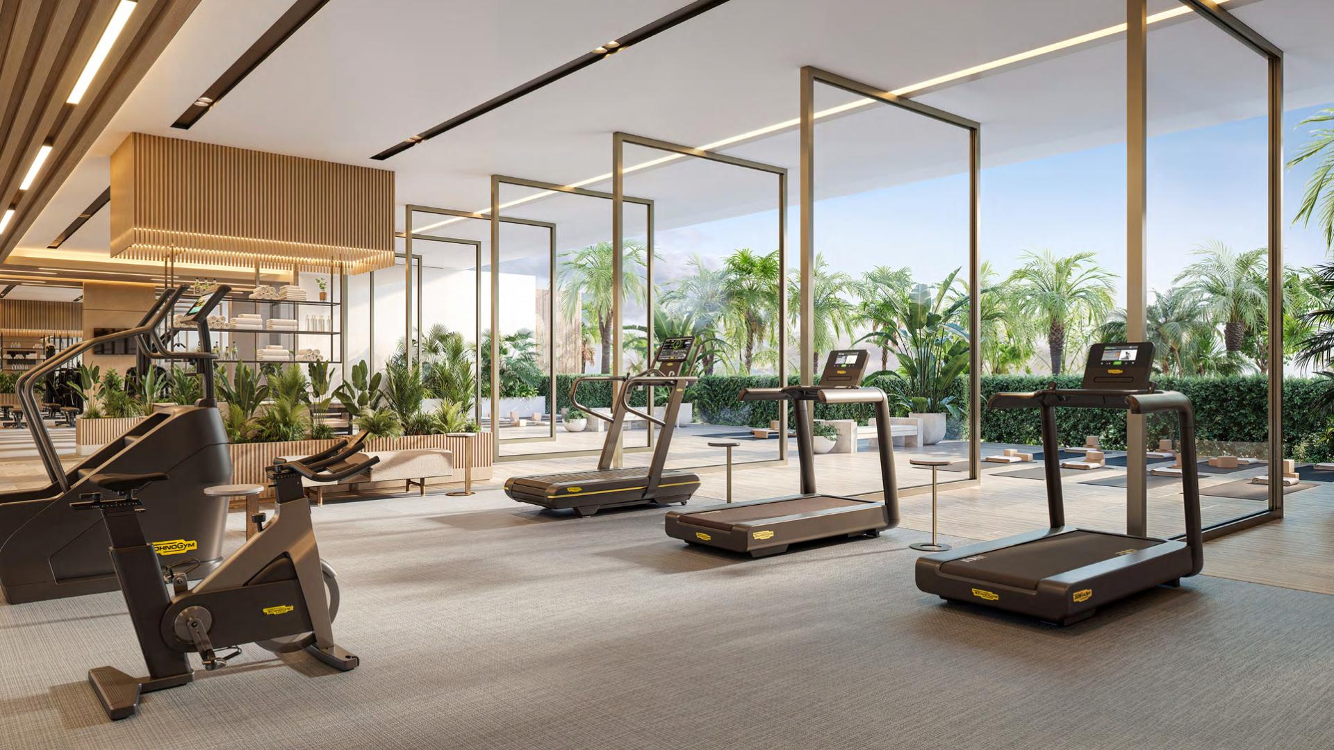 Fitness studio glazed onto landscaped greenery.