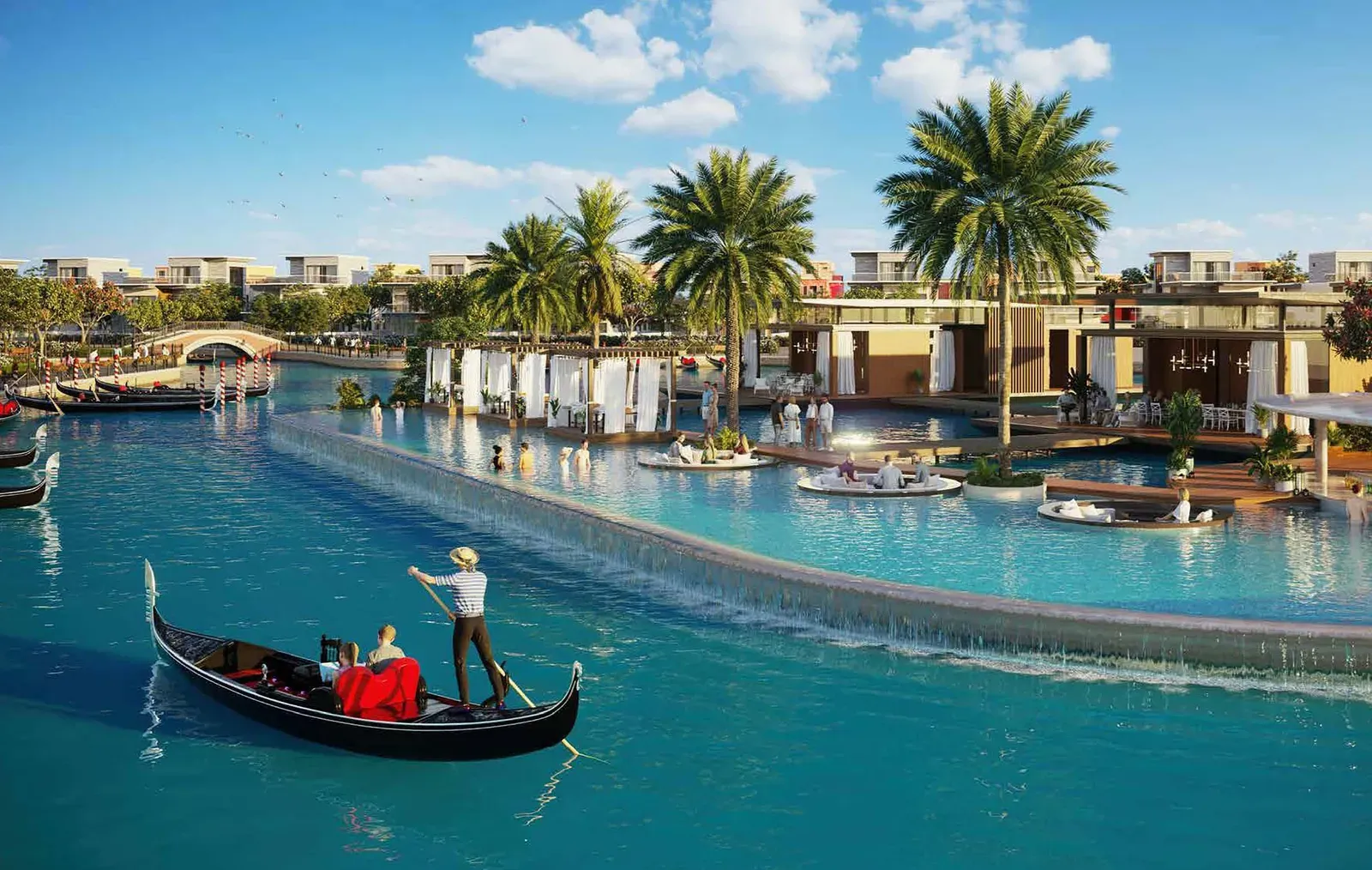 Gondolier steering a gondola along the lagoon past waterfront townhouses at DAMAC Lagoons