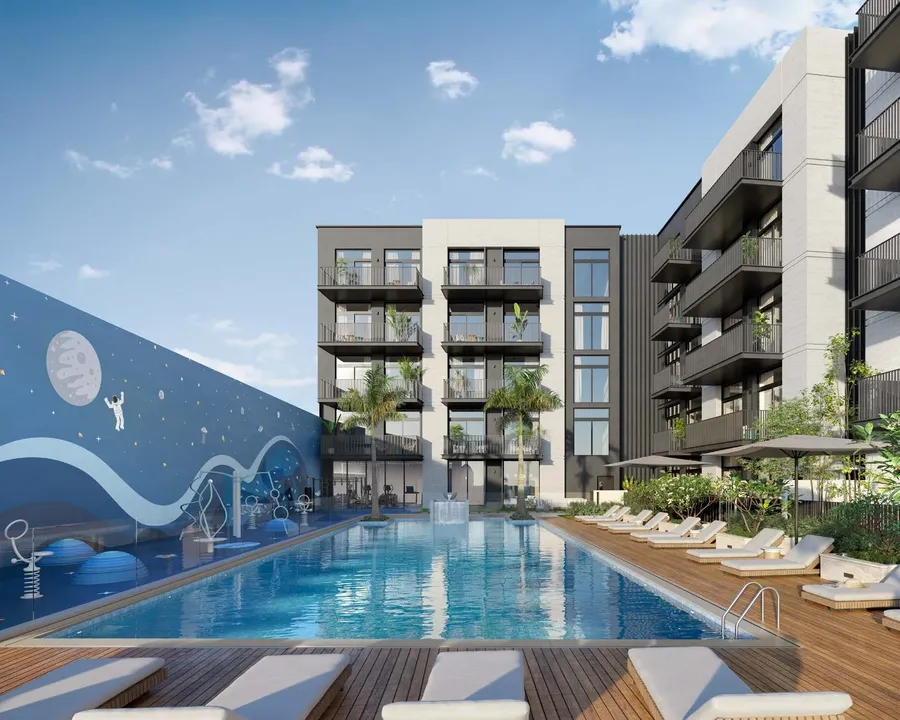 Lap Pool With Sun Loungers at Belmont Residences.